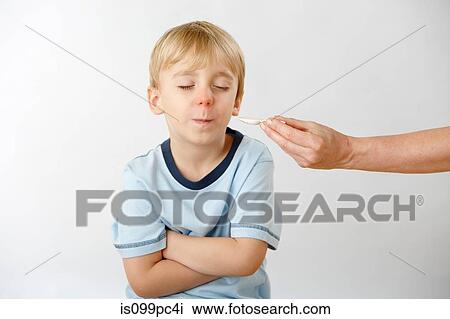 Parent trying to give son medicine, boy refusing View Large Photo Image Stock Image - Parent trying to give son medicine, boy refusing. Fotosearch