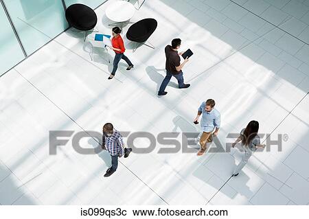 People walking on office concourse View Large Photo Image Stock Image - People walking on office concourse. Fotosearch