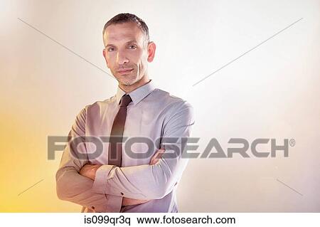 Portrait of a businessman with arms crossed View Large Photo Image Stock Photography - Portrait of a businessman with arms crossed. Fotosearch