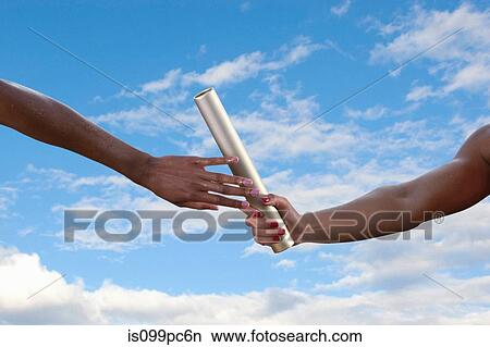 Relay athletes passing a baton, close up View Large Photo Image Picture - Relay athletes passing a baton, close up. Fotosearch