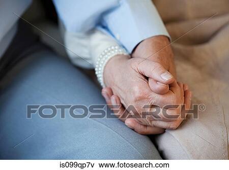 Stock Photo - Senior couple holding hands. Fotosearch