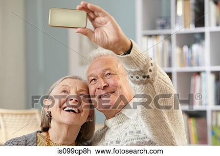 Senior couple using camera phone View Large Photo Image Stock Image - Senior couple using camera phone. Fotosearch
