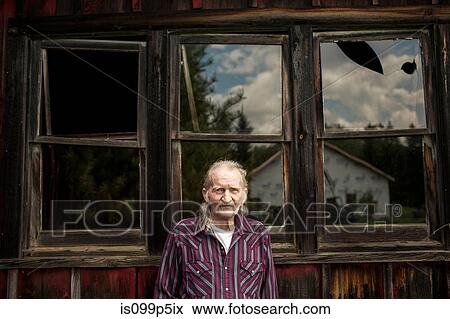 Senior man outside shack, portrait View Large Photo Image Stock Photo - Senior man outside shack, portrait. Fotosearch