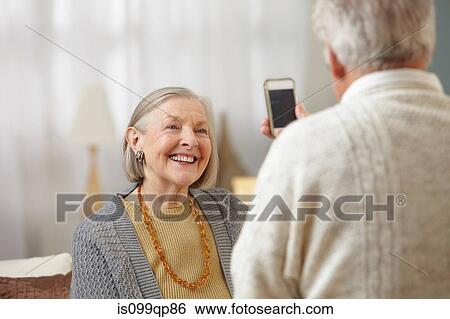 Stock Photograph - Senior man using camera phone. Fotosearch