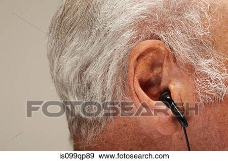 Senior man wearing earphones, close up View Large Photo Image Stock Photo - Senior man wearing earphones, close up. Fotosearch