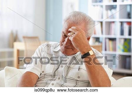 Stock Photograph - Senior man with head in hand. Fotosearch
