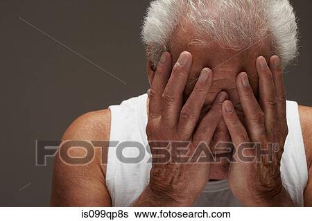Stock Photograph - Senior man with head in hands. Fotosearch