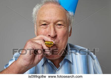 Senior man with party blower, portrait View Large Photo Image Stock Photo - Senior man with party blower, portrait. Fotosearch