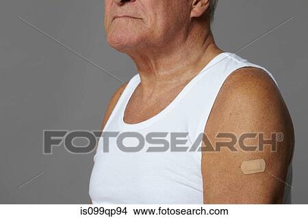 Picture - Senior man with plaster on arm. Fotosearch