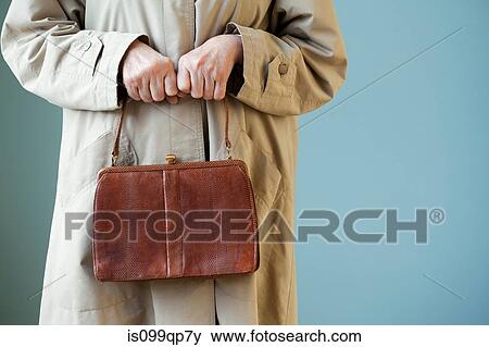 Senior woman holding handbag View Large Photo Image Stock Photo - Senior woman holding handbag. Fotosearch