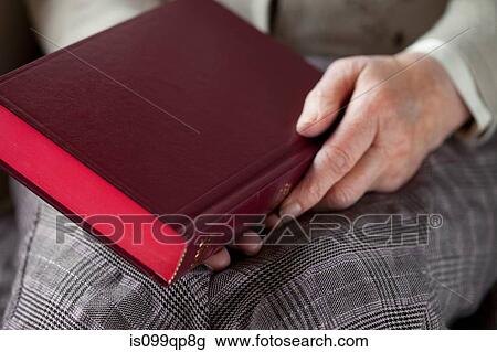 Senior woman holding hardback book View Large Photo Image Stock Image - Senior woman holding hardback book. Fotosearch