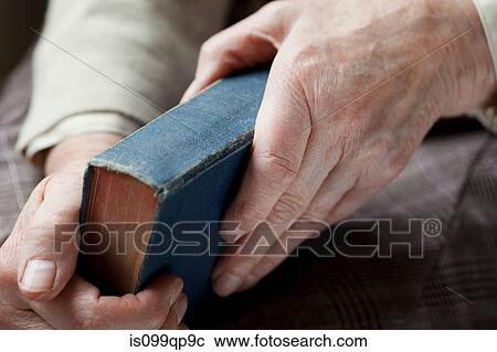 Senior woman holding hardback book View Large Photo Image Stock Image - Senior woman holding hardback book. Fotosearch