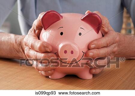 Senior woman holding piggy bank View Large Photo Image Stock Image - Senior woman holding piggy bank. Fotosearch