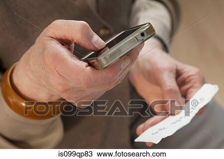 Stock Image - Senior woman using smartphone. Fotosearch