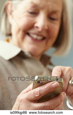 Senior woman using smartphone View Large Photo Image Stock Photo - Senior woman using smartphone. Fotosearch