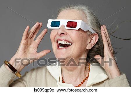 Stock Image - Senior woman wearing 3d glasses. Fotosearch