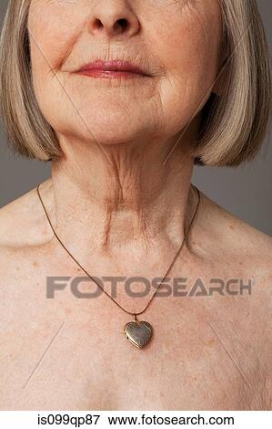 Stock Photo - Senior woman wearing pendant. Fotosearch