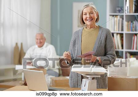 Senior woman weighing packages View Large Photo Image Stock Photography - Senior woman weighing packages. Fotosearch