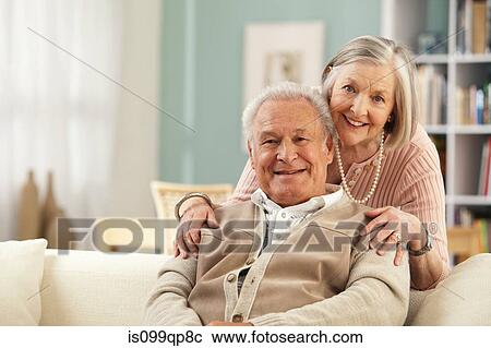 Stock Image - Senior woman with hands on mans shoulders. Fotosearch