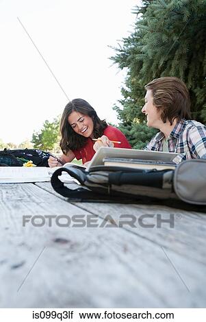 Teenage couple studying at picnic table in park View Large Photo Image Stock Image - Teenage couple studying at picnic table in park. Fotosearch
