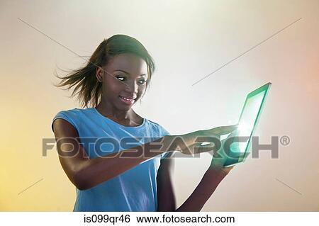 Teenage girl touching digital tablet with lights View Large Photo Image Stock Photograph - Teenage girl touching digital tablet with lights. Fotosearch