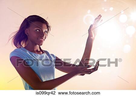 Stock Image - Teenage girl touching lights. Fotosearch
