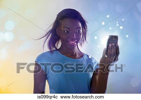 Teenage girl using illuminated cellphone View Large Photo Image Stock Image - Teenage girl using illuminated cellphone. Fotosearch