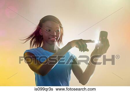 Teenage girl using illuminated cellphone View Large Photo Image Stock Photograph - Teenage girl using illuminated cellphone. Fotosearch