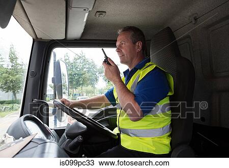 Truck driver on walkie talkie View Large Photo Image Stock Image - Truck driver on walkie talkie. Fotosearch
