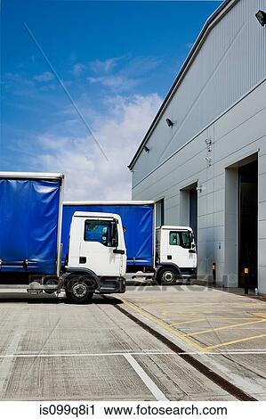 Stock Image - Truck parked outside distribution warehouse. Fotosearch