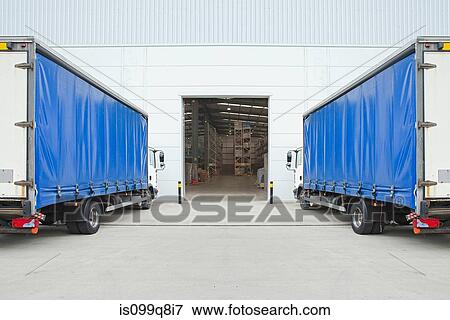 Trucks parked outside distribution warehouse View Large Photo Image Stock Photo - Trucks parked outside distribution warehouse. Fotosearch