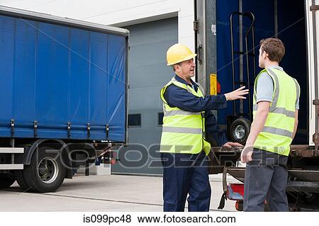 Two men loading truck View Large Photo Image Stock Photo - Two men loading truck. Fotosearch