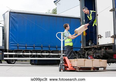 Two men unloading cardboard boxes from truck View Large Photo Image Stock Photograph - Two men unloading cardboard boxes from truck. Fotosearch