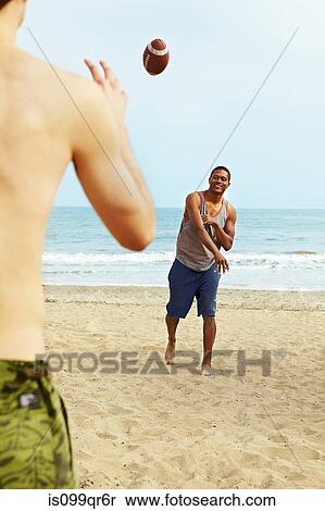 Two young men playing rugby on beach View Large Photo Image Stock Photography - Two young men playing rugby on beach. Fotosearch