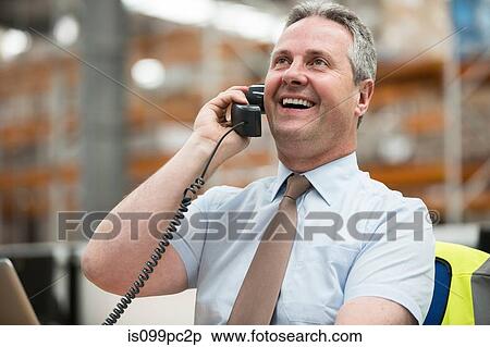 Warehouse manager on the phone View Large Photo Image Stock Photography - Warehouse manager on the phone. Fotosearch