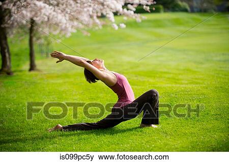 Woman in crescent moon yoga position in park View Large Photo Image Stock Photo - Woman in crescent moon yoga position in park. Fotosearch