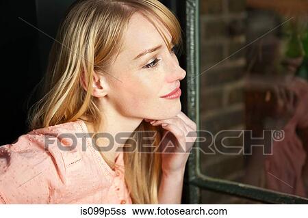 Woman looking through window, close up View Large Photo Image Stock Photograph - Woman looking through window, close up. Fotosearch