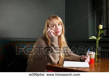 Woman on phone making notes View Large Photo Image Stock Photograph - Woman on phone making notes. Fotosearch