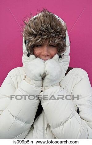 Woman wearing puffer jacket with hood View Large Photo Image Picture - Woman wearing puffer jacket with hood. Fotosearch