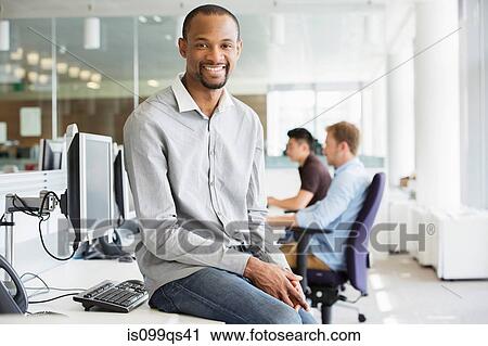 Young businessman in office View Large Photo Image Stock Image - Young businessman in office. Fotosearch
