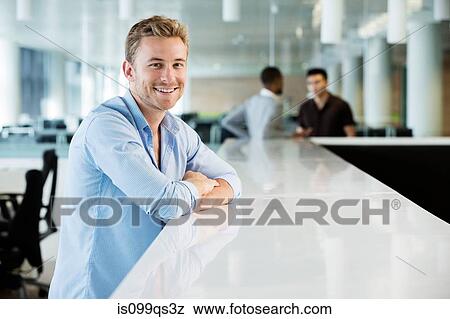 Stock Photo - Young businessman in office. Fotosearch
