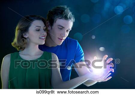Stock Photograph - Young couple holding light. Fotosearch