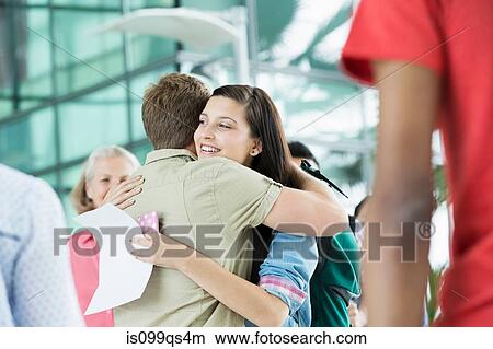 Young couple hugging in airport View Large Photo Image Picture - Young couple hugging in airport. Fotosearch