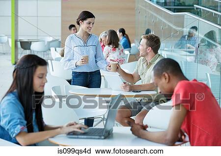 Stock Image - Young couple in canteen area. Fotosearch