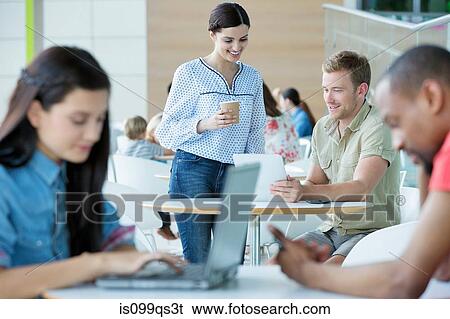 Young couple in canteen area View Large Photo Image Stock Photograph - Young couple in canteen area. Fotosearch