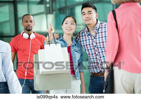 Young couple in shopping mall View Large Photo Image Stock Photograph - Young couple in shopping mall. Fotosearch