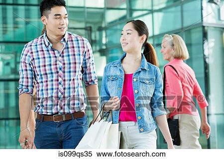 Young couple in shopping mall View Large Photo Image Stock Photography - Young couple in shopping mall. Fotosearch