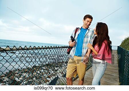 Young couple on boardwalk View Large Photo Image Stock Image - Young couple on boardwalk. Fotosearch