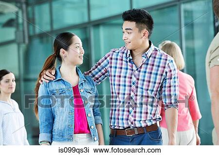 Young couple walking together View Large Photo Image Stock Image - Young couple walking together. Fotosearch