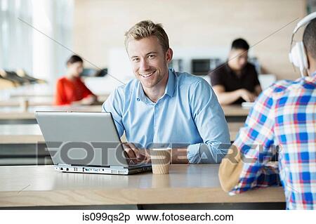 Young man in break room with laptop View Large Photo Image Stock Photography - Young man in break room with laptop. Fotosearch